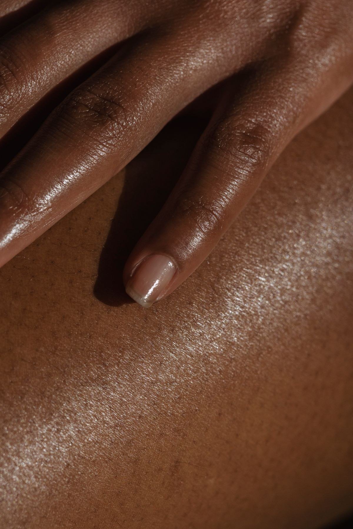 Close-up of jelly pink chrome nails showing sheer pink translucent shine