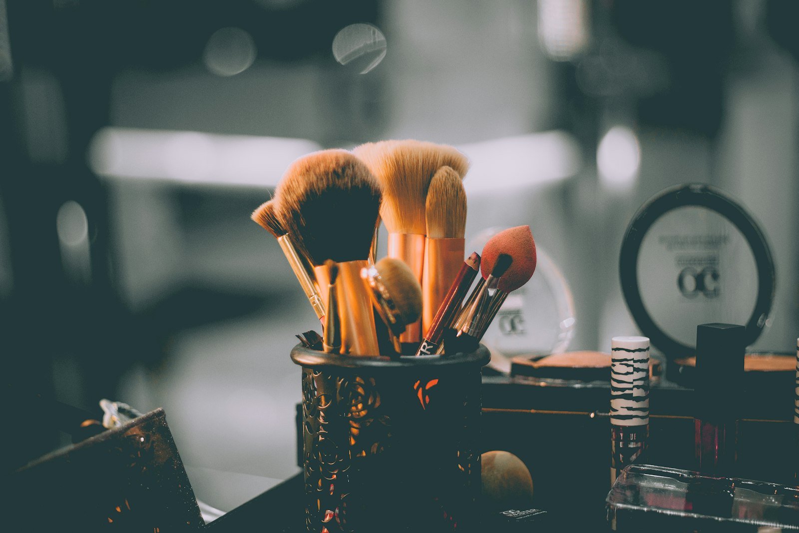 Woman applying frosted eyeshadow makeup with a brush