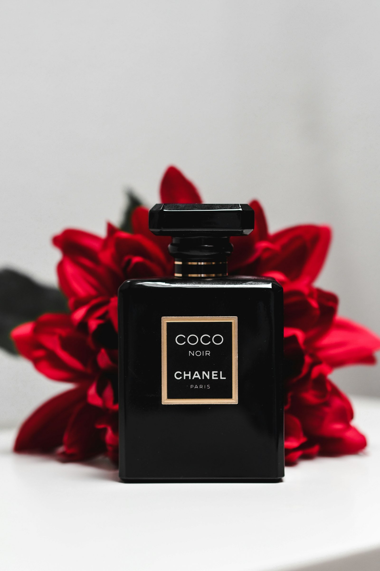 Pink perfume bottle styled in a feminine vanity aesthetic