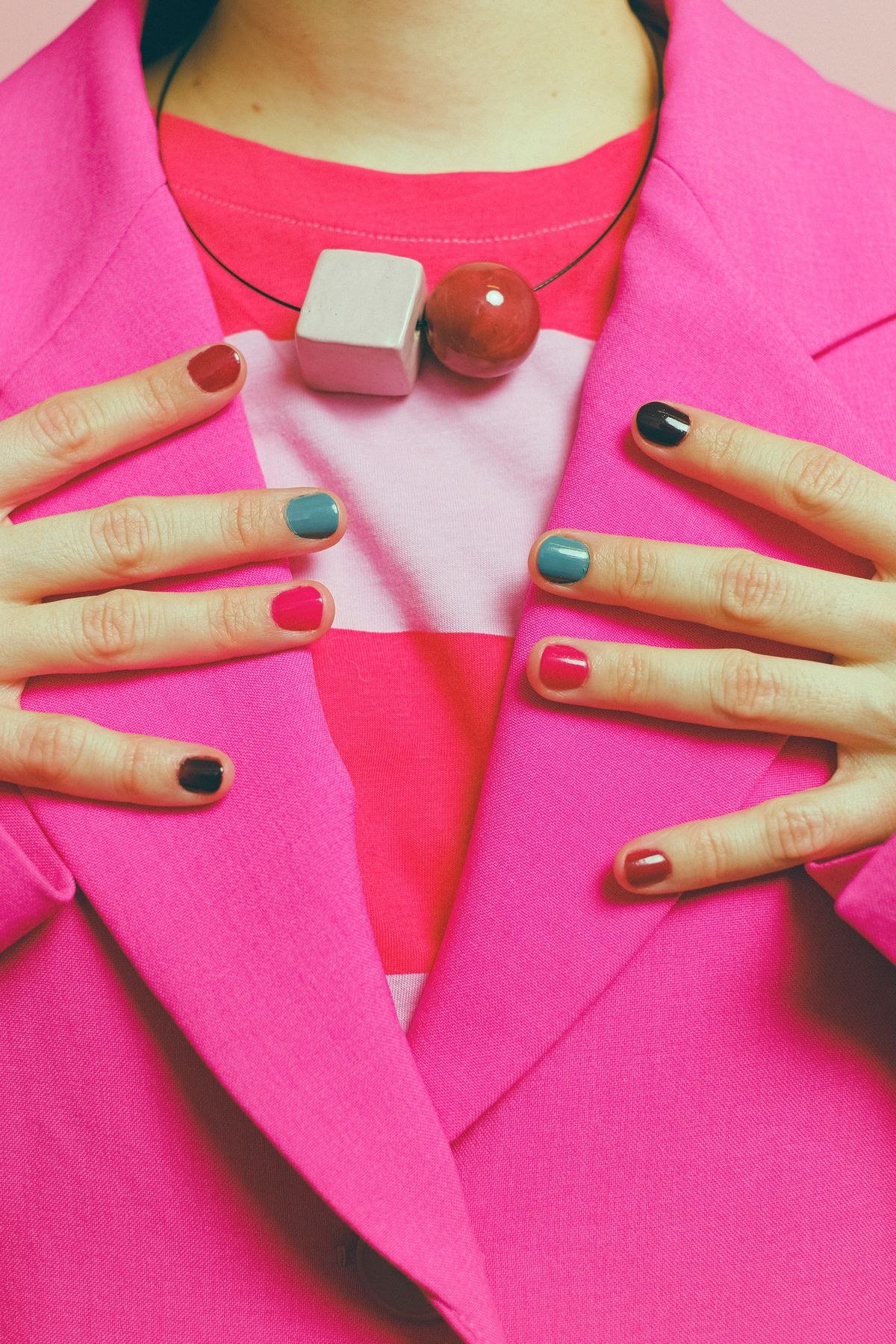 Full coverage hot pink chrome nails on almond shaped nails