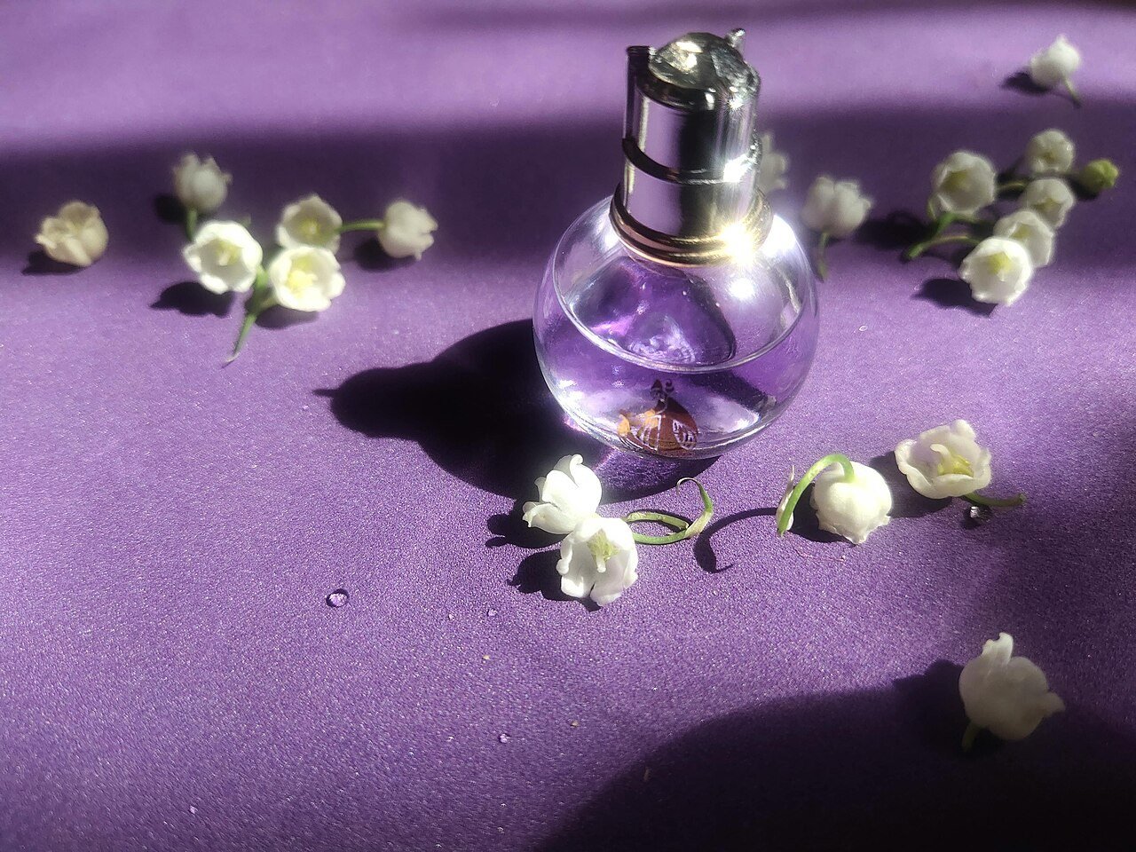 Elegant Perfume Bottle with Lily of the Valley Flowers