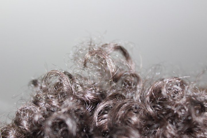 Curly butterfly cut ideas with soft curtain bangs parted in the middle