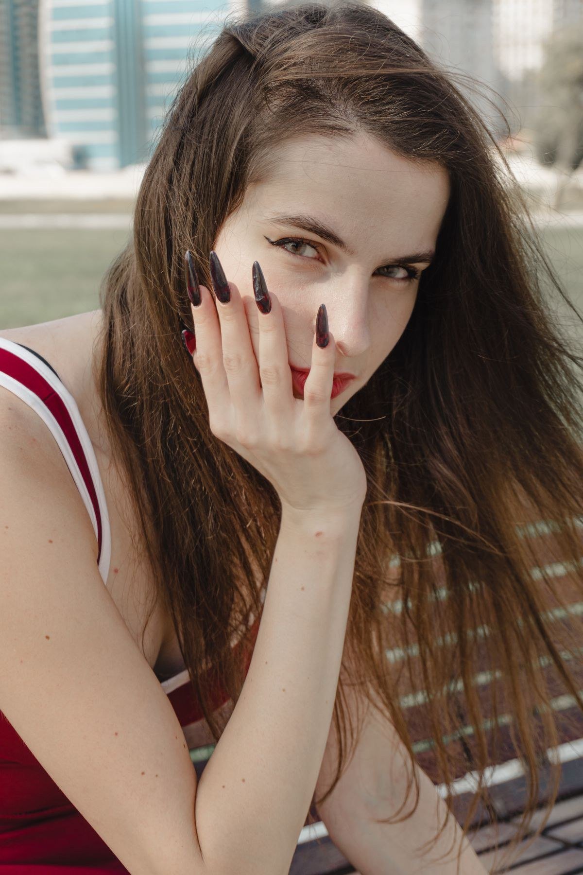 Long almond dark red cat eye nails with elegant light beam
