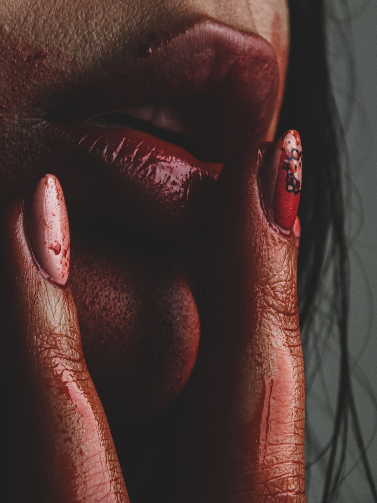 Dark red cat eye nails with intricate gold nail art details