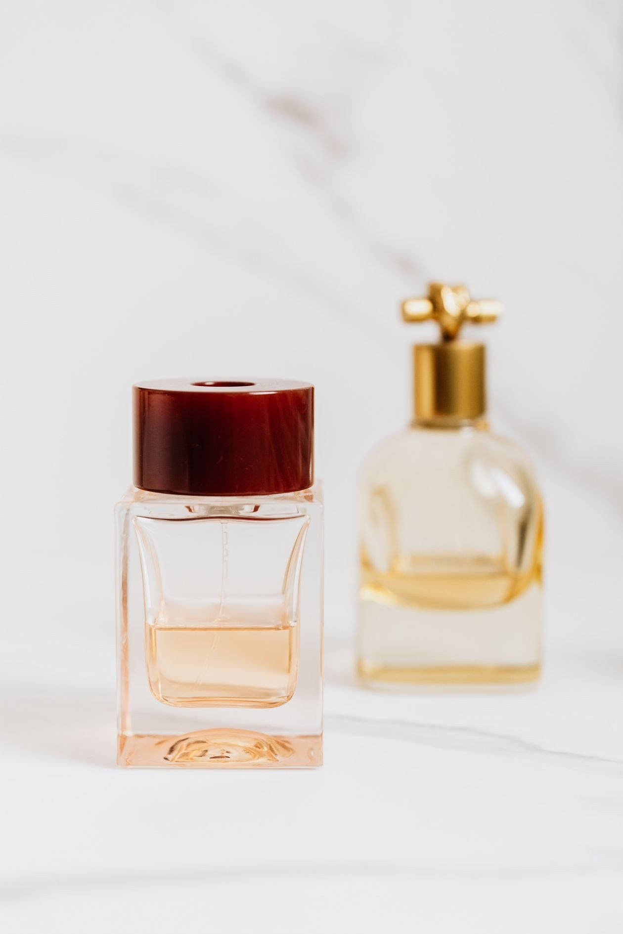 Close-up of elegant perfume bottles on a marble surface, showcasing luxury fragrances