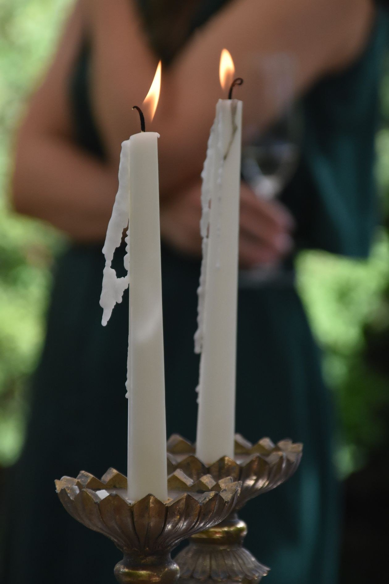 Close-up of burning candles with melted wax at an elegant indoor event