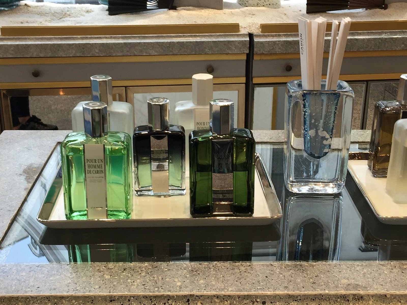 Attendant helping a wedding guest choose fragrance oils at the bar