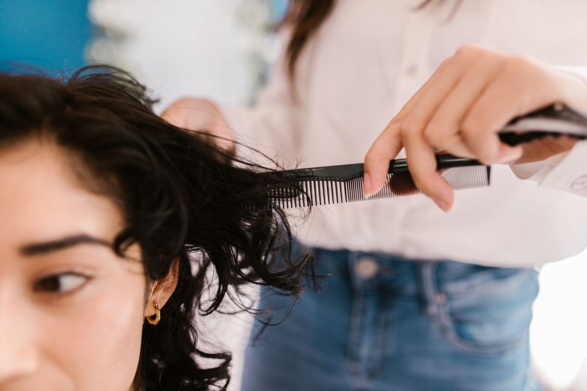 Curly wolf cut with wispy textured fringe around the face