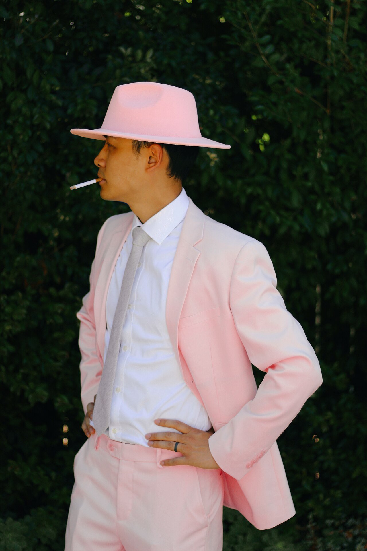 Man in a pink suit and fedora costume