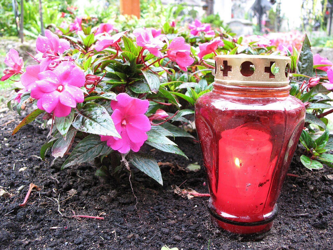 Red candle with pink flowers