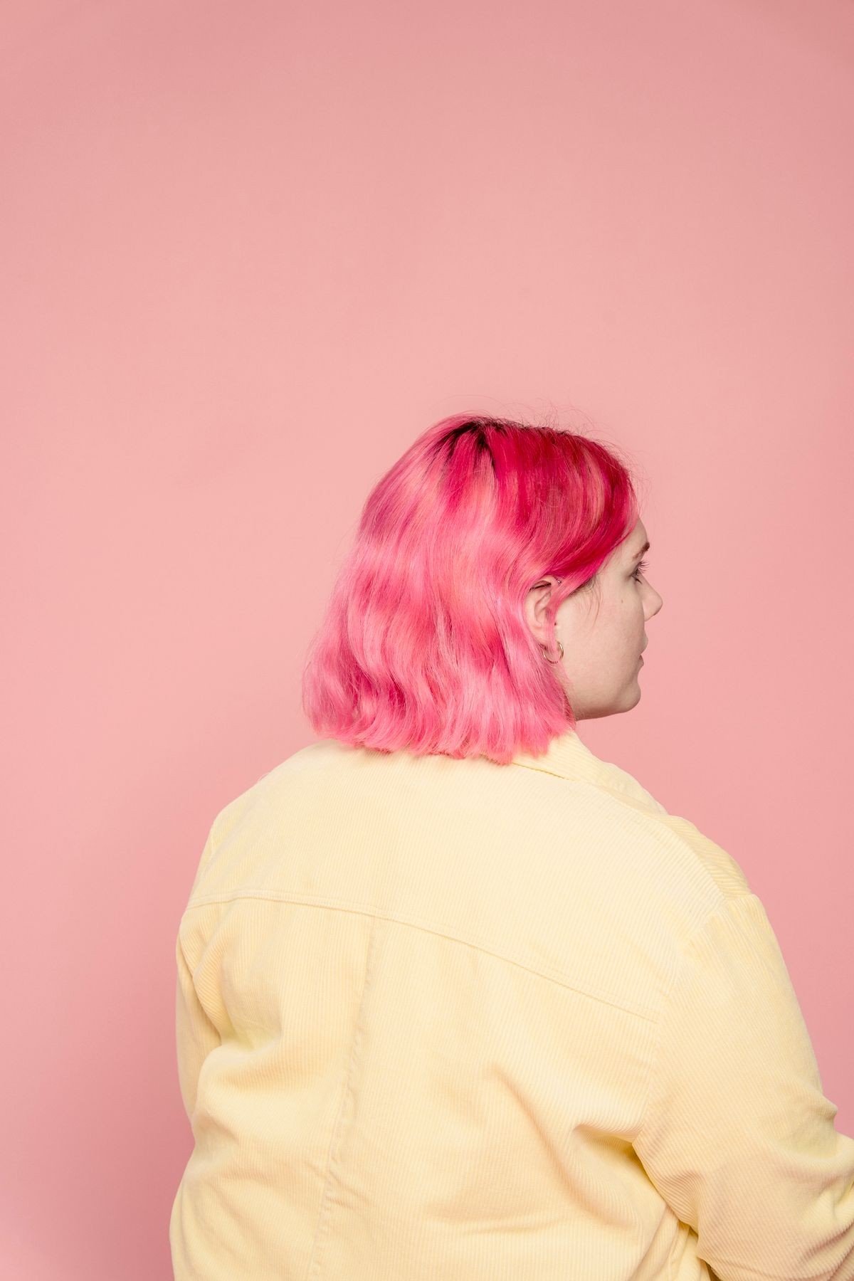 Dusty rose pink hair styled in soft gentle waves