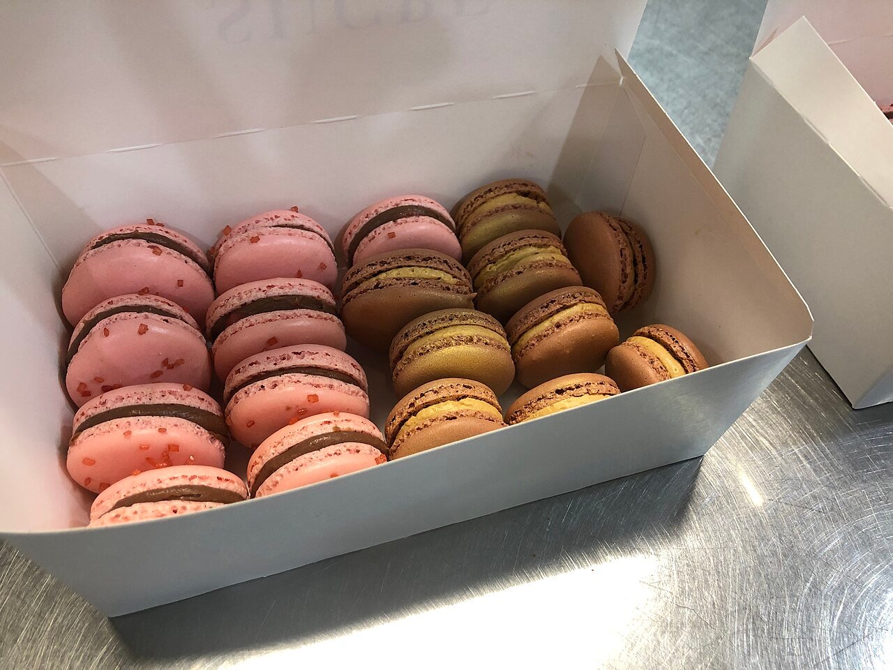 Pink and chocolate macarons in a box