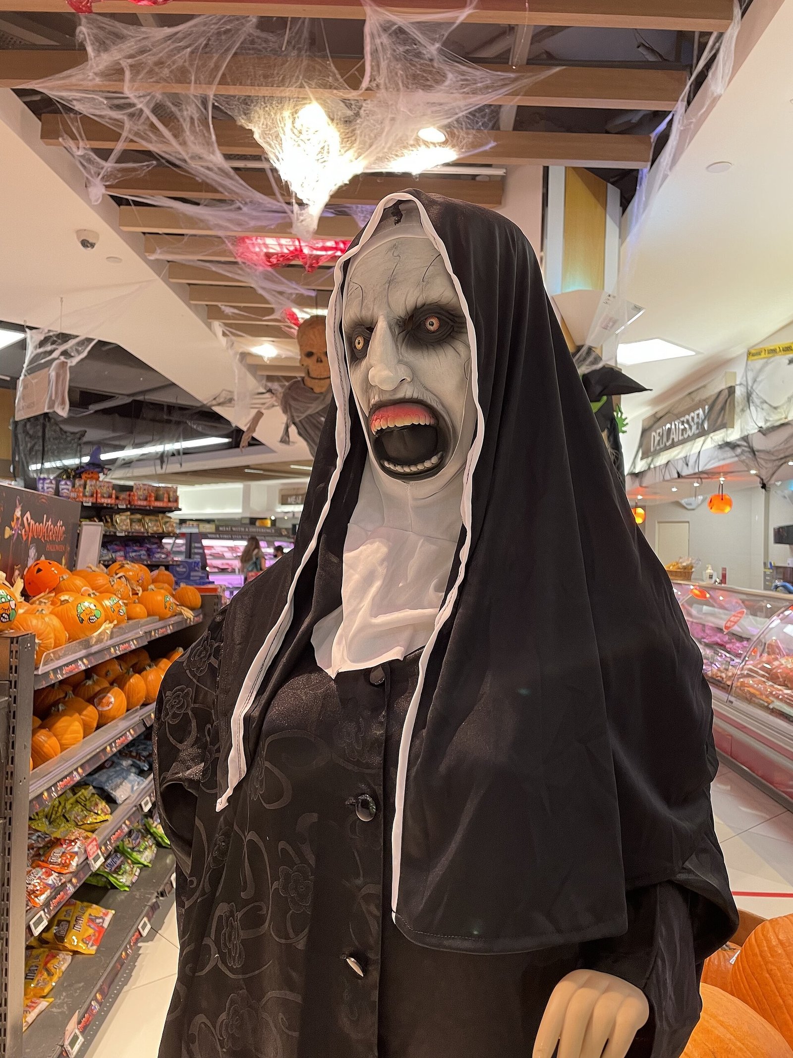Modest adaptation of a demon hunter costume with hijab and hunter accessories