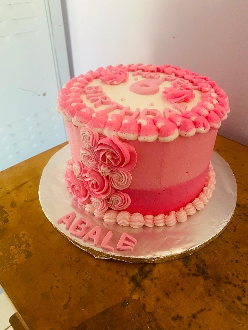 Pink frosted birthday cake