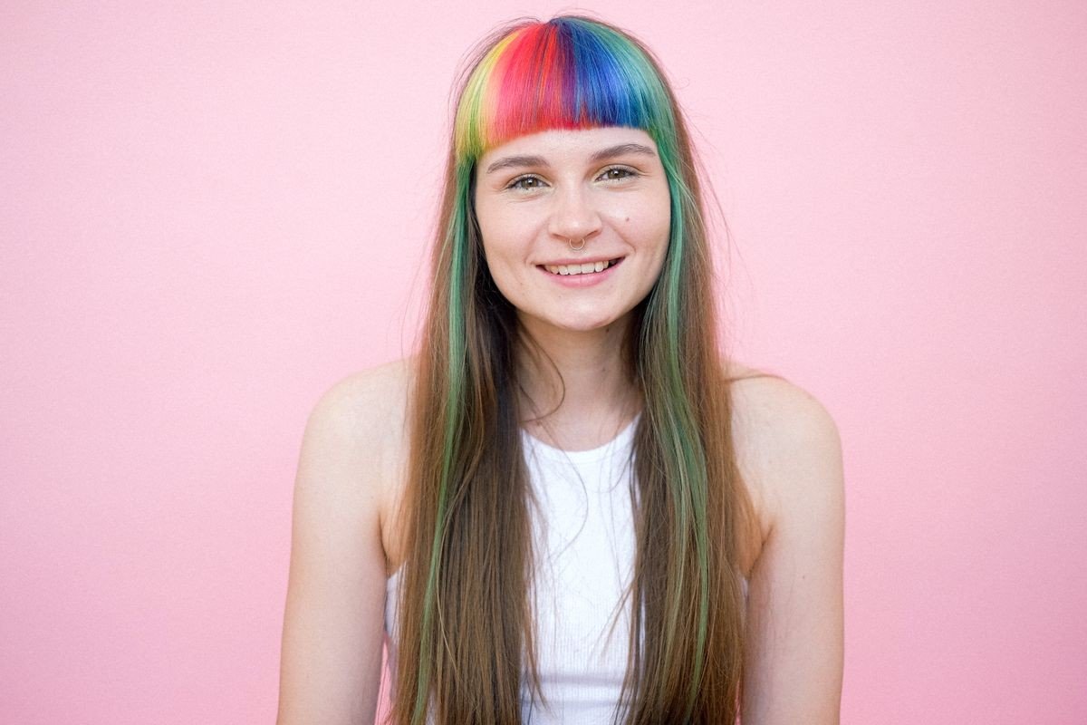 Pink streaks on blonde hair with bright colour