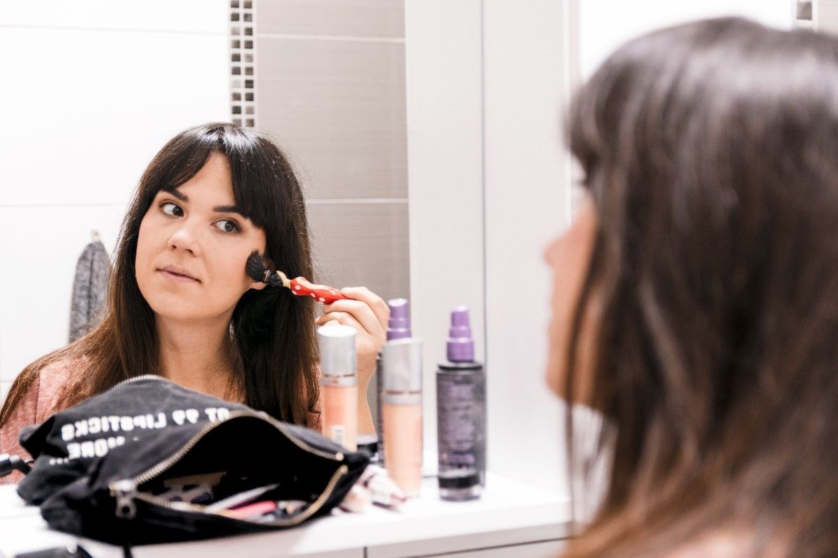 Applying soft diffused blush for natural cloud skin flush