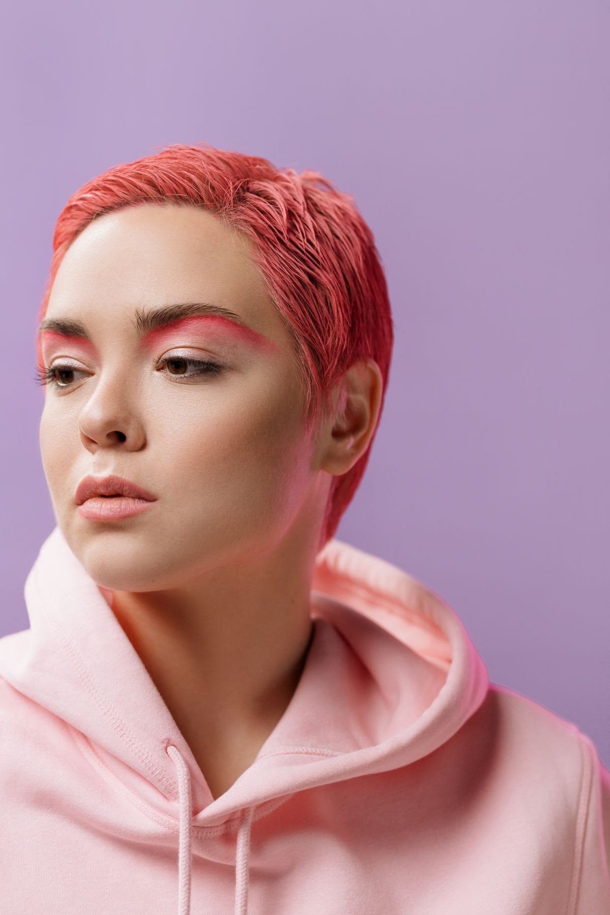 Short pixie haircut with pink streaks