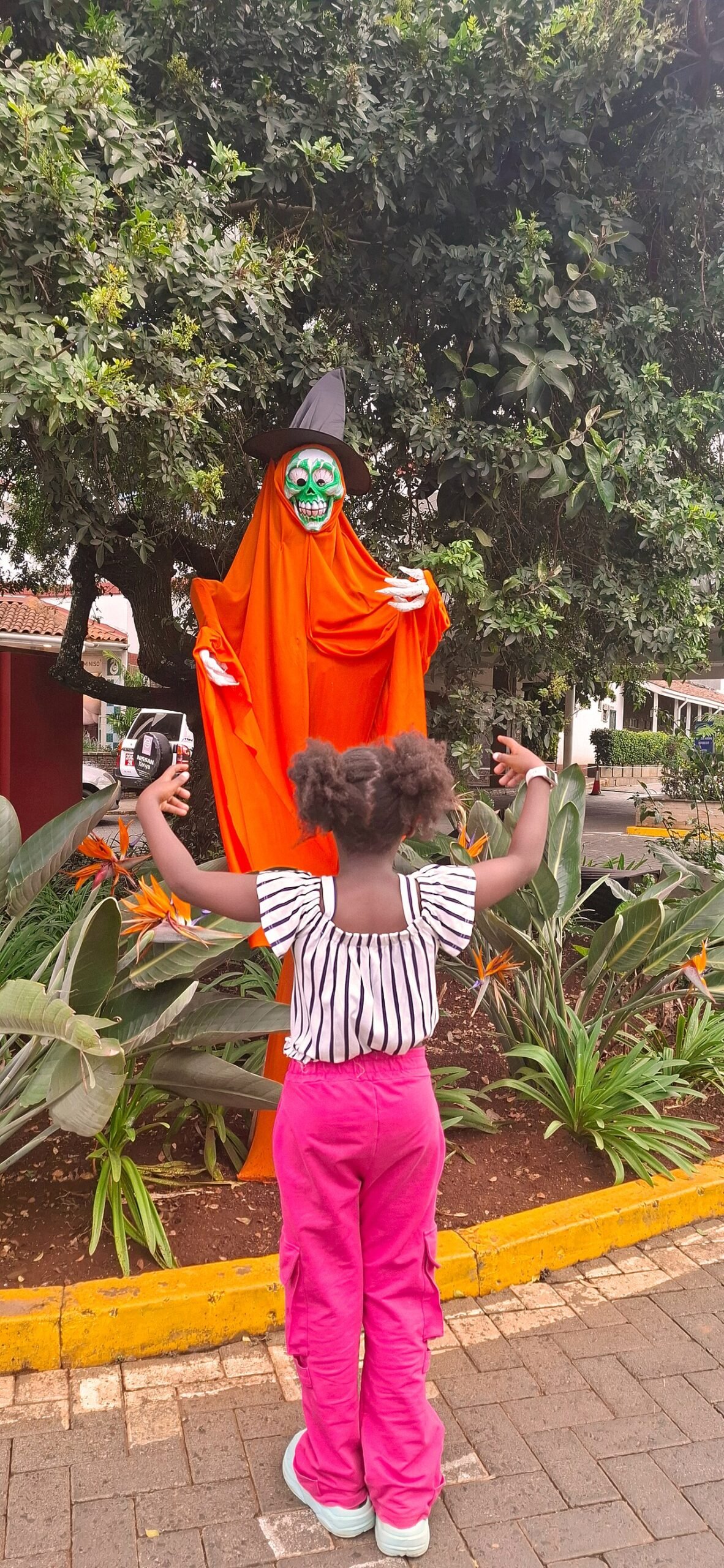 Child with a Halloween skeleton decoration