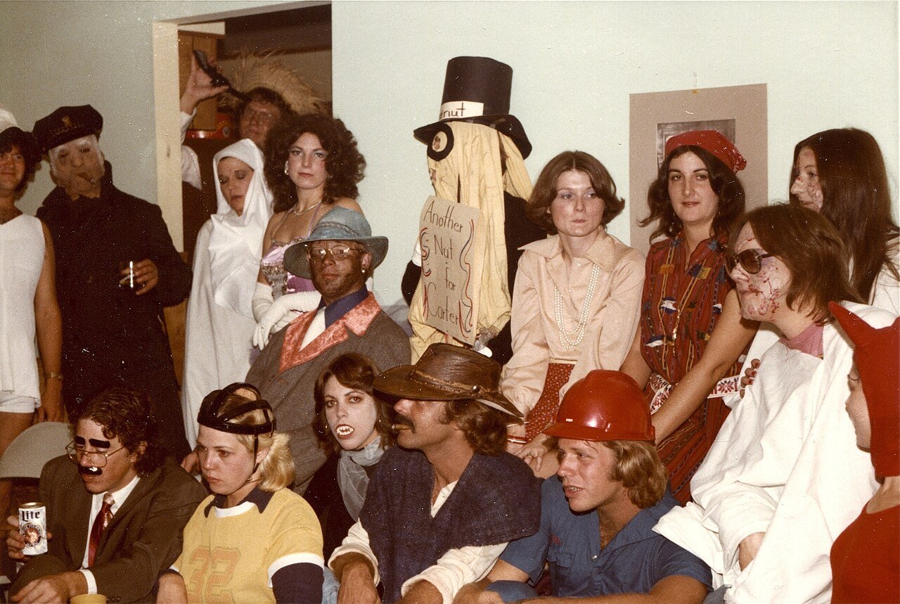 Group of friends in coordinated modern witch costumes at Halloween party