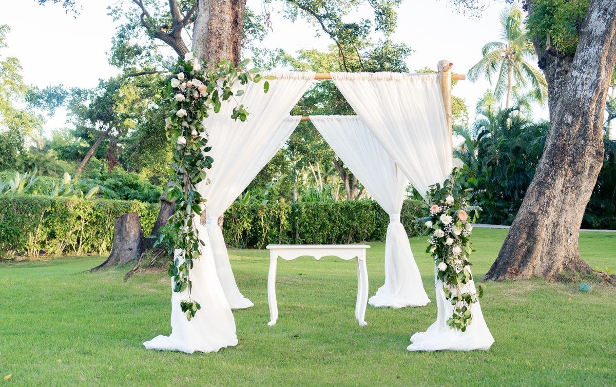 Stained glass wedding arch with colorful panes at outdoor ceremony