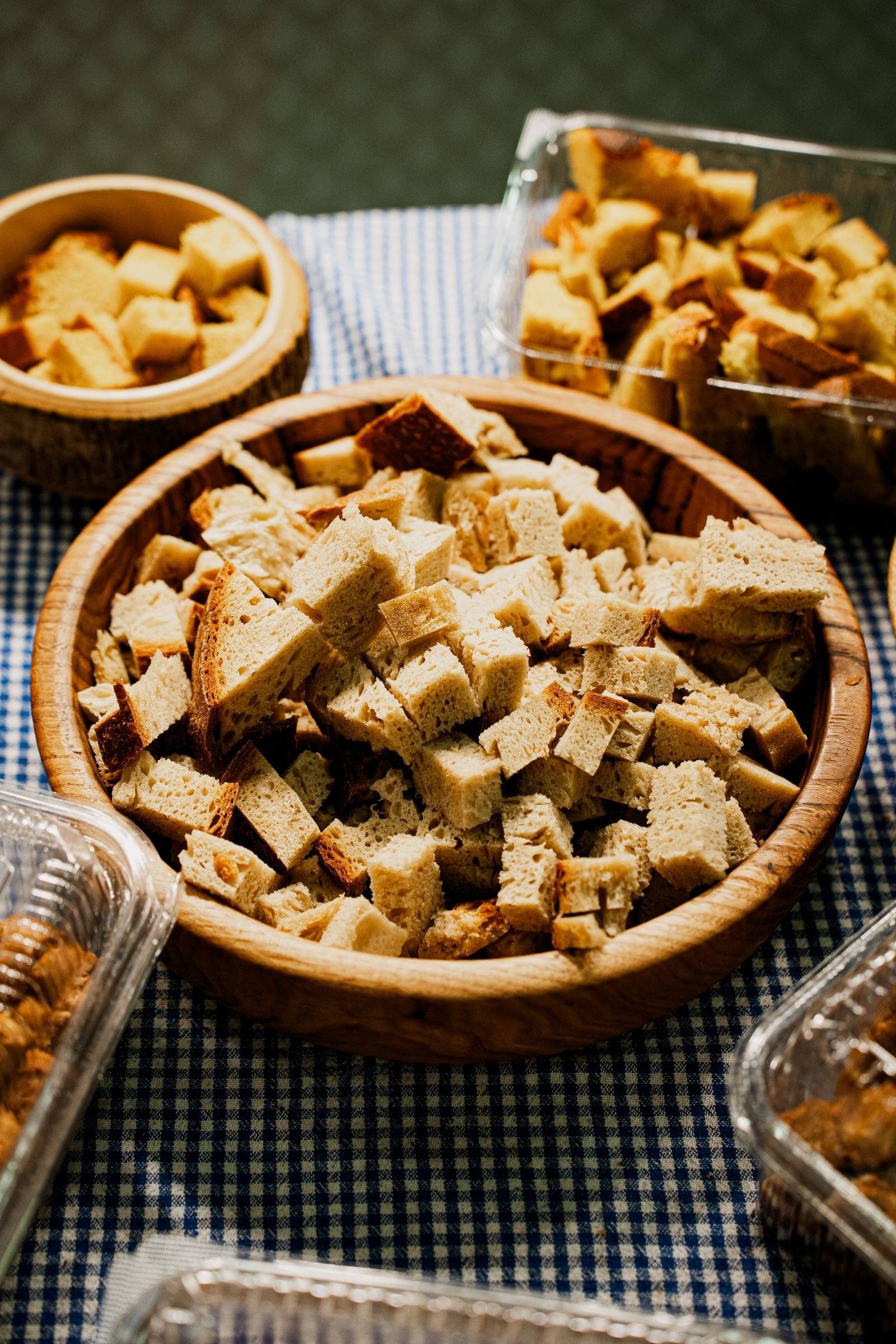 Fresh ingredients for cornbread stuffing arranged on a wooden board