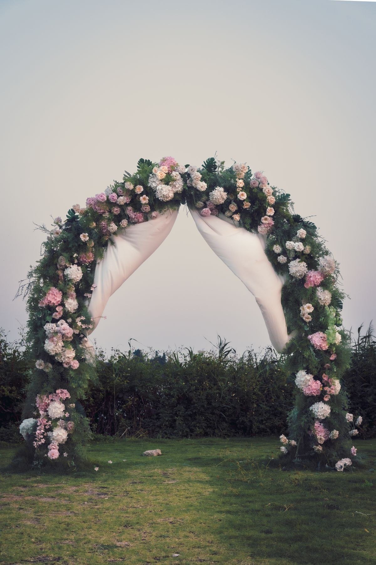 Pastel watercolor stained glass wedding arch in soft pink and blue