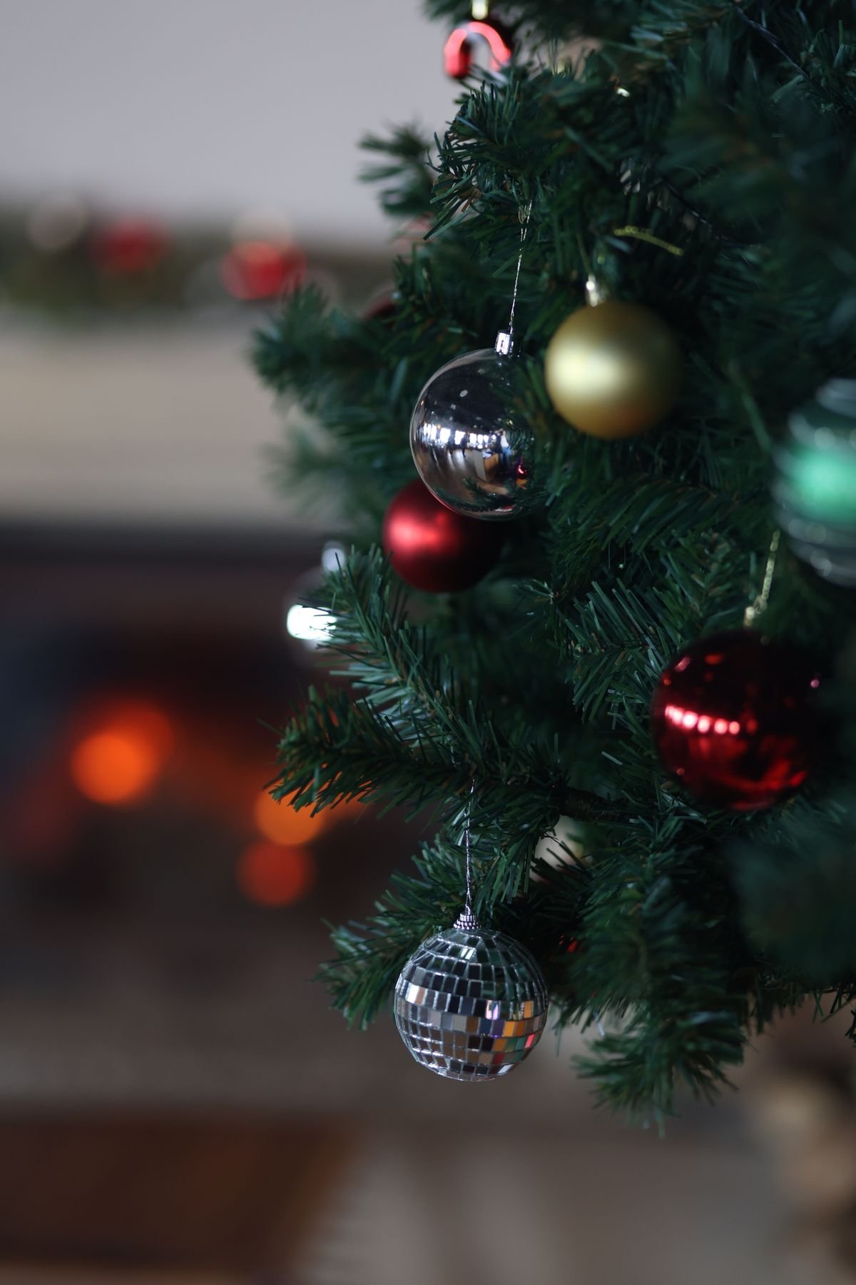 Wide wired ribbon cascading down a flocked Christmas tree in elegant loops