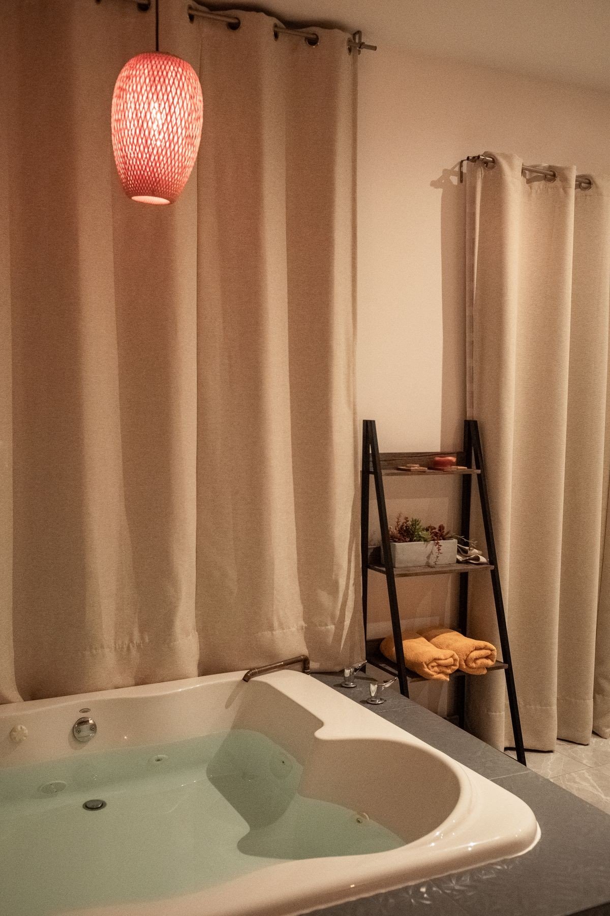Tidy bathroom shelf with body lotion, cleanser, and a folded towel