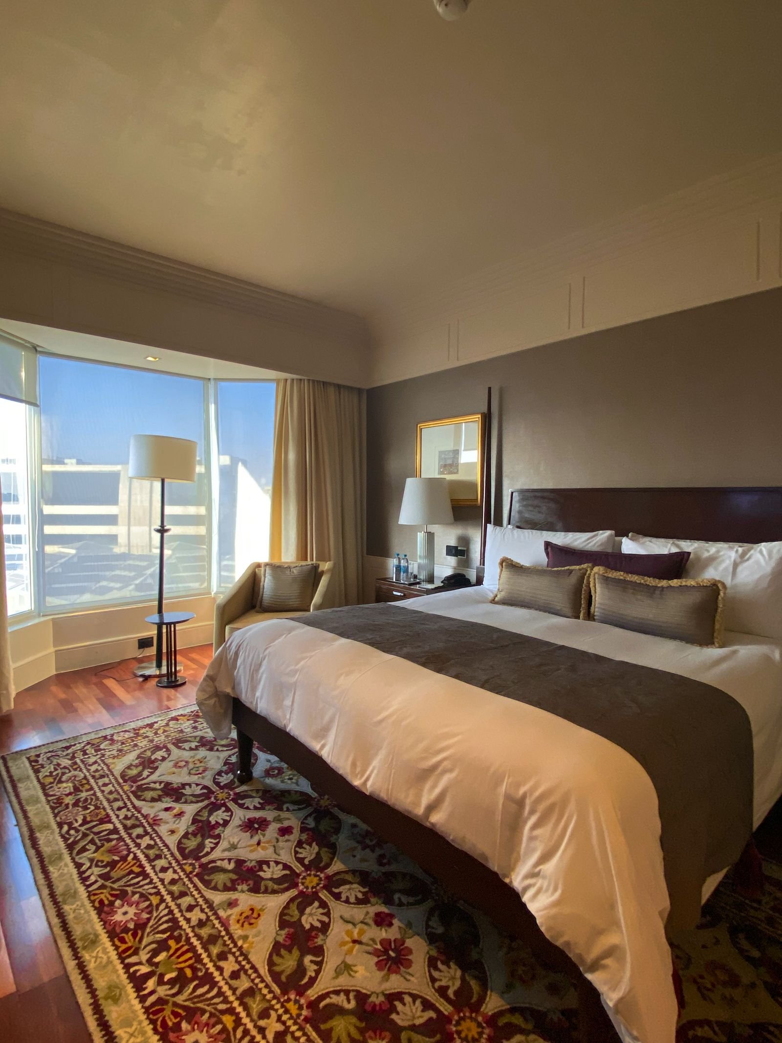 Hotel room suite with ornate mirrors and circus-themed accents