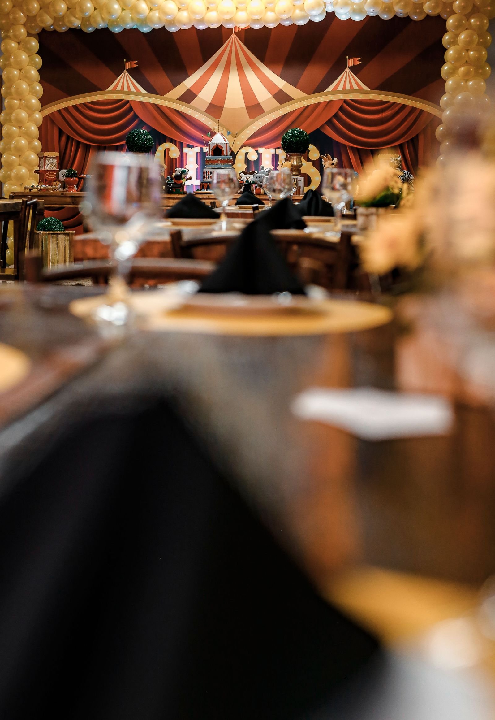 Elegant circus-themed party setup with detailed decor and tables indoors