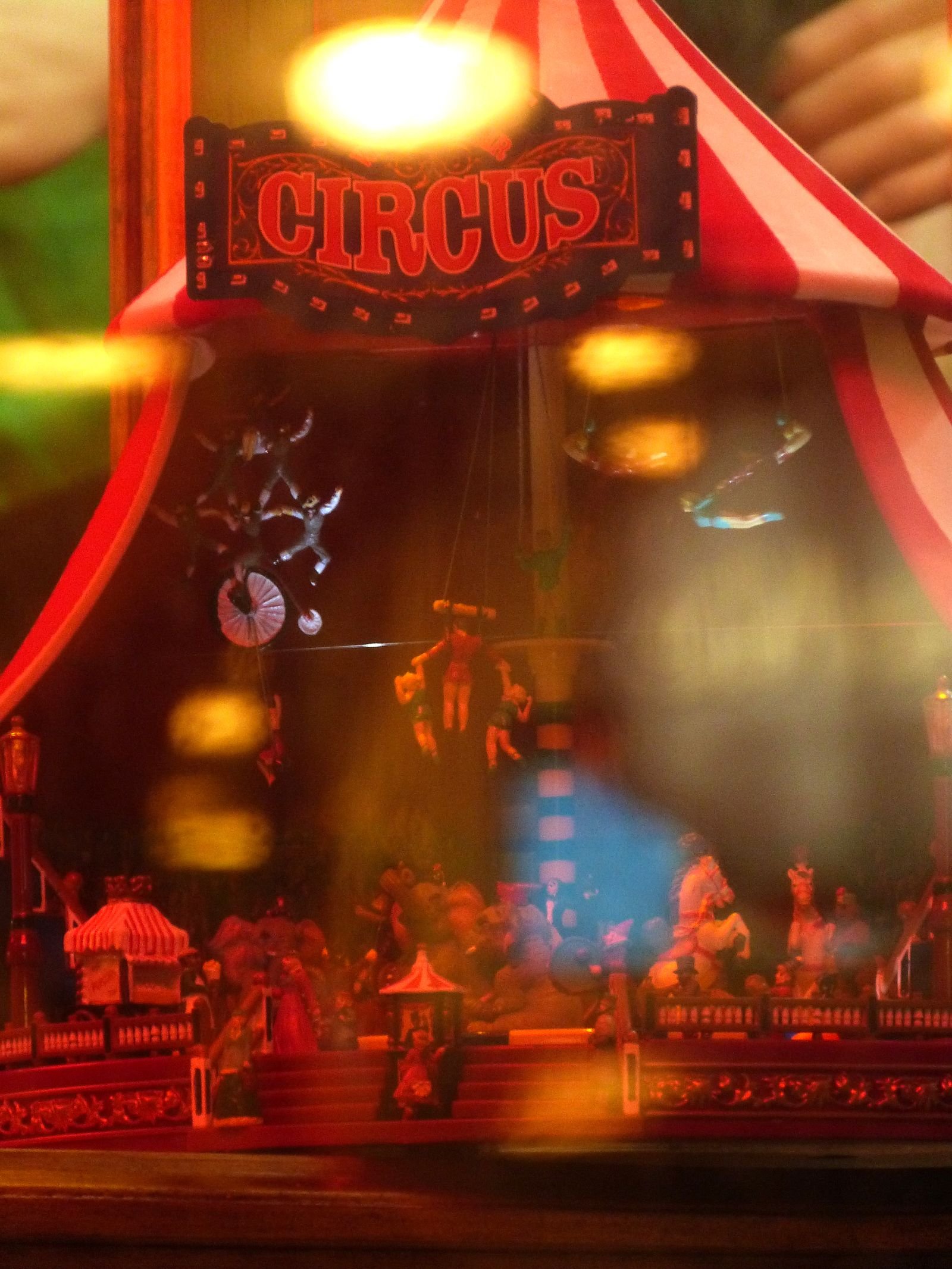 Whimsical circus miniature display with vibrant lighting and intricate details