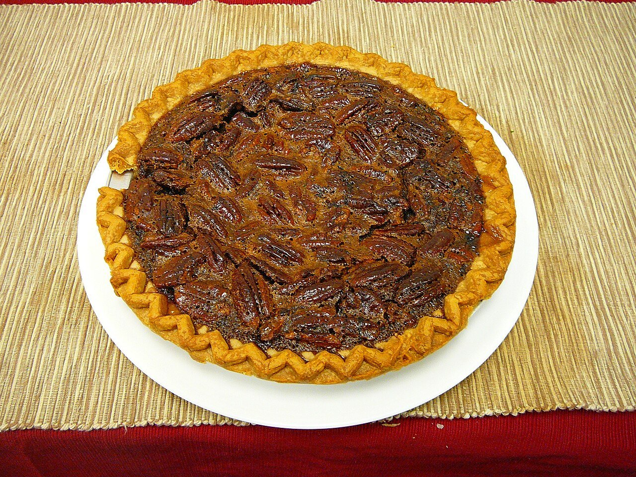 Finished pecan pie cake displayed on a festive holiday dessert table