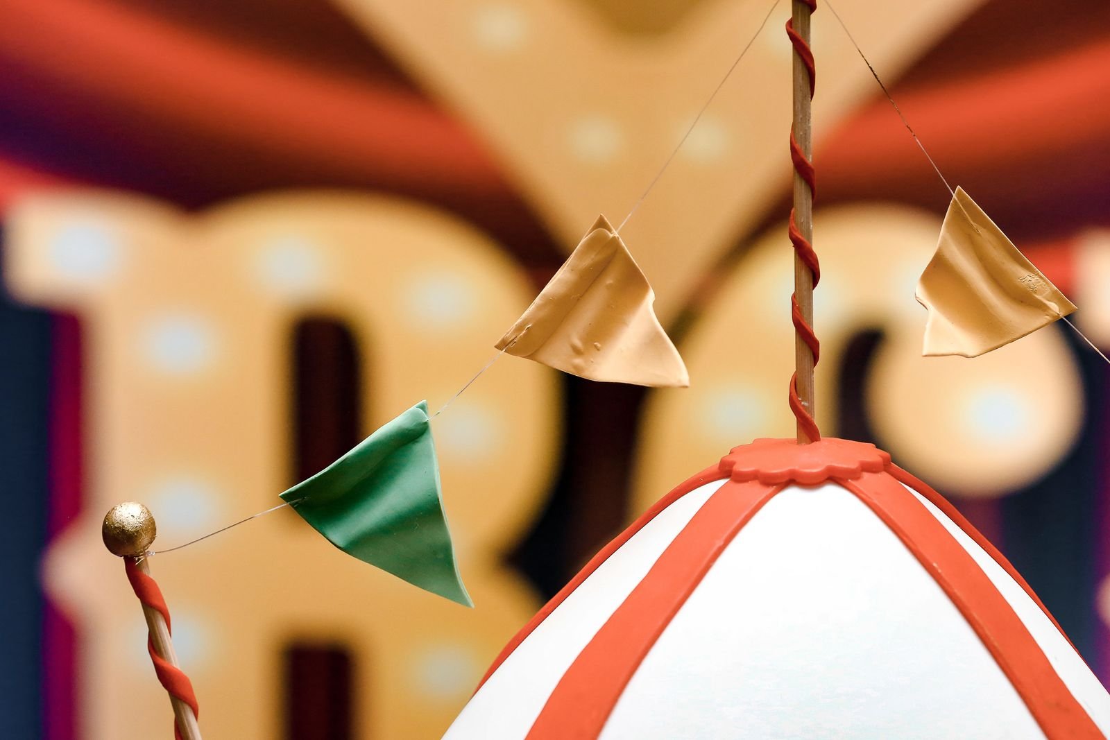 Vibrant circus-themed decoration with colourful flags and striped tent top