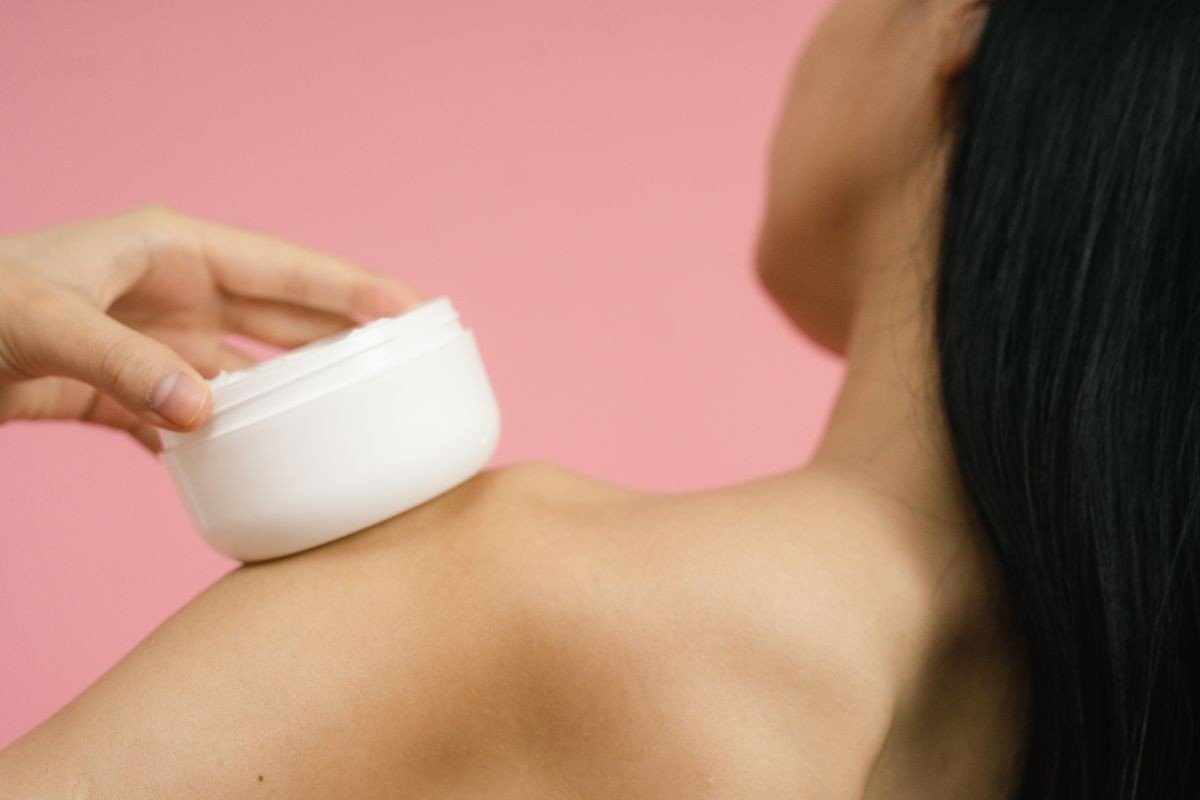 Retinol body lotion bottle on a bathroom shelf with soft light