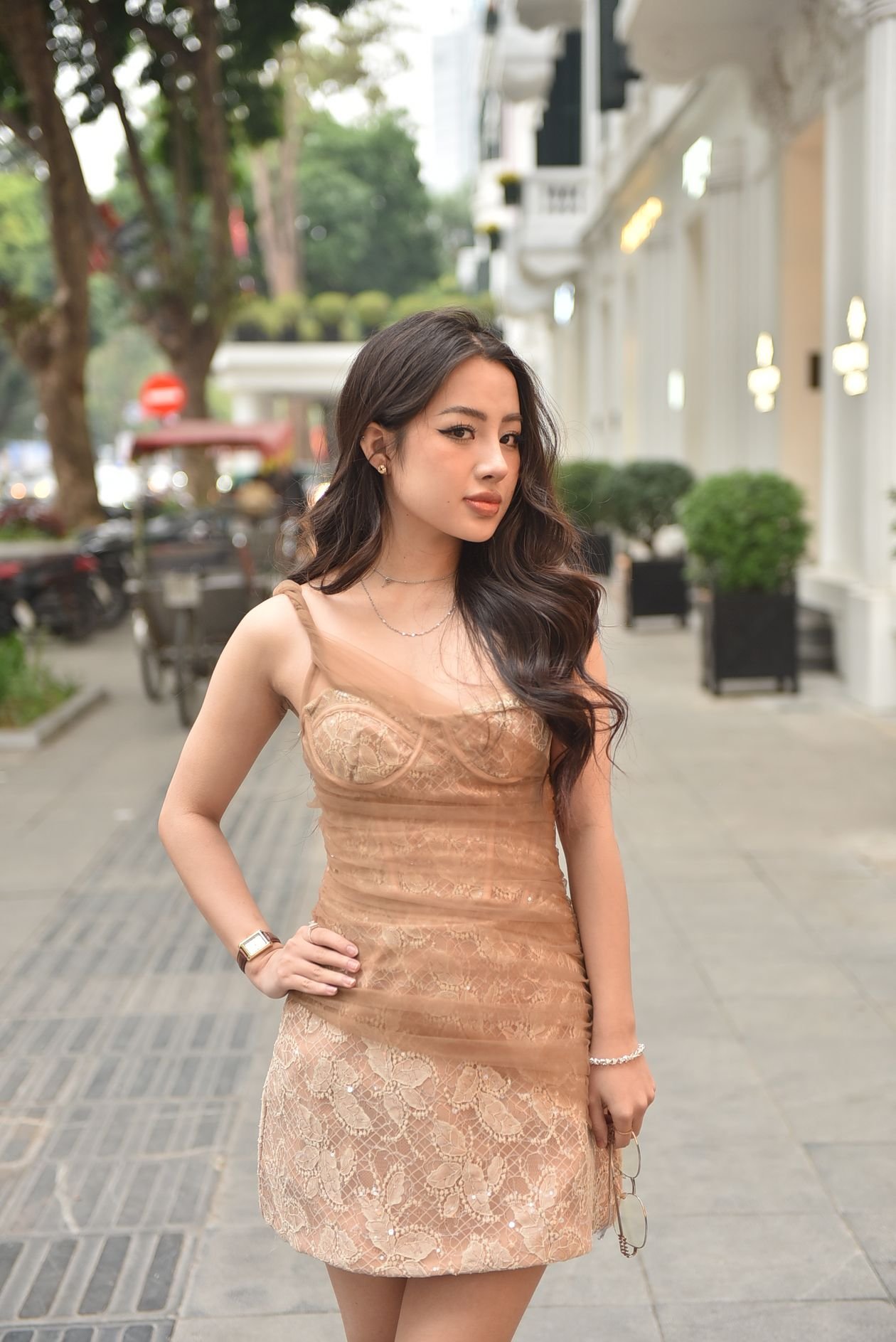 Elegant woman in lace dress on a city street