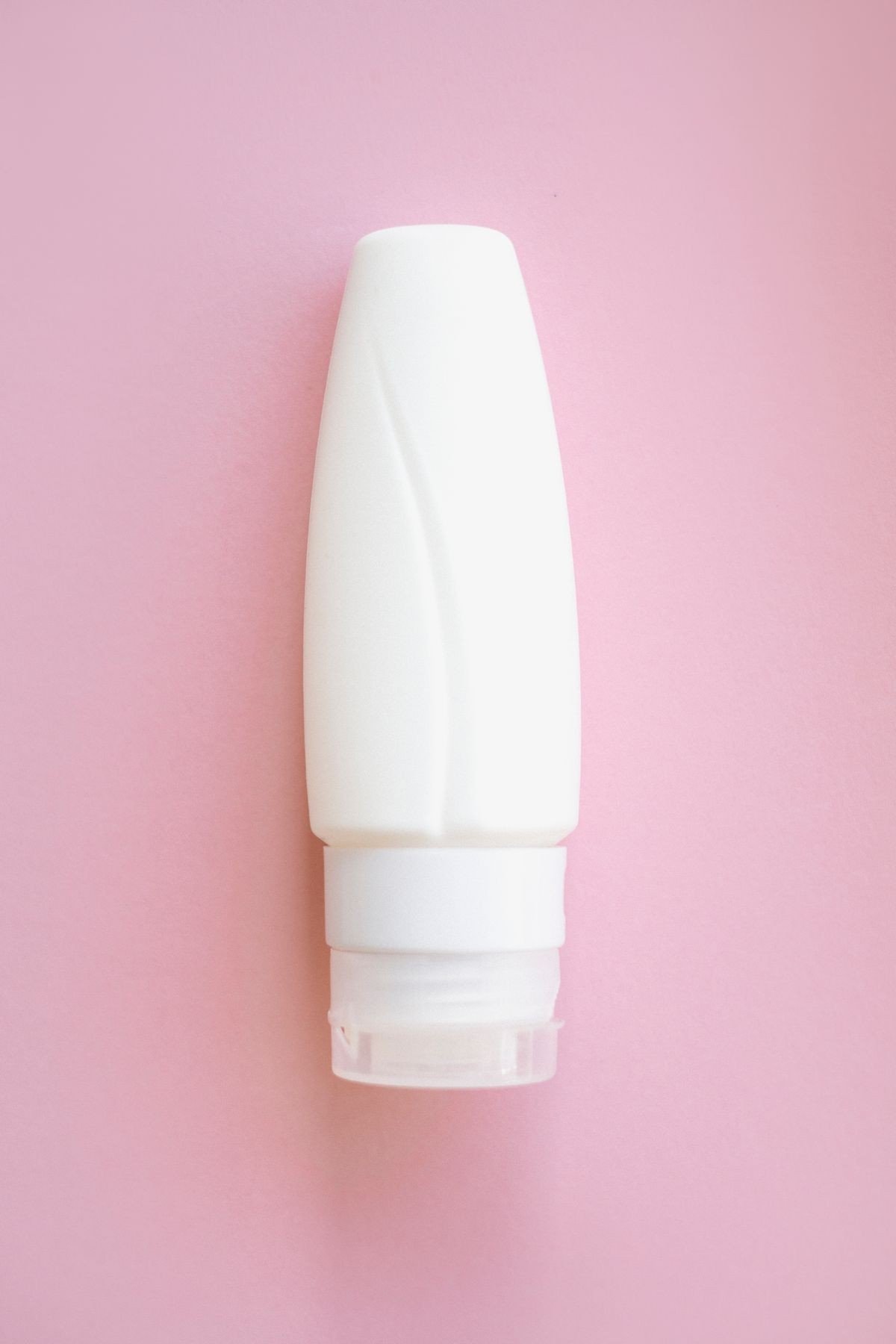 Sunscreen applied to arms alongside retinol body care routine