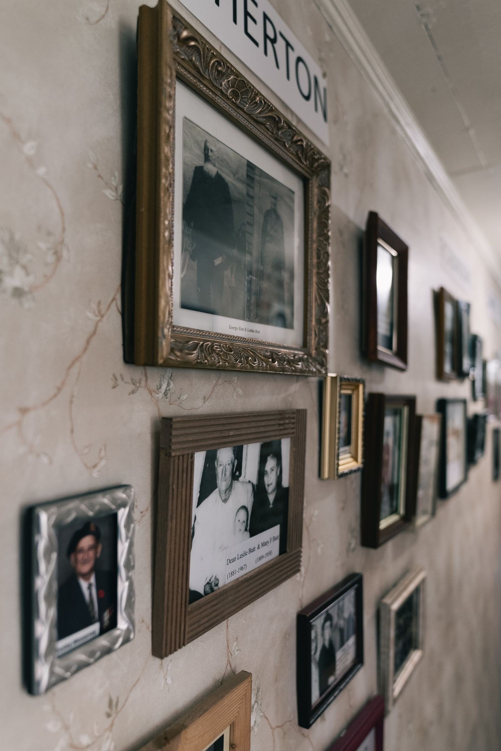 Family photos following the slope of a staircase wall