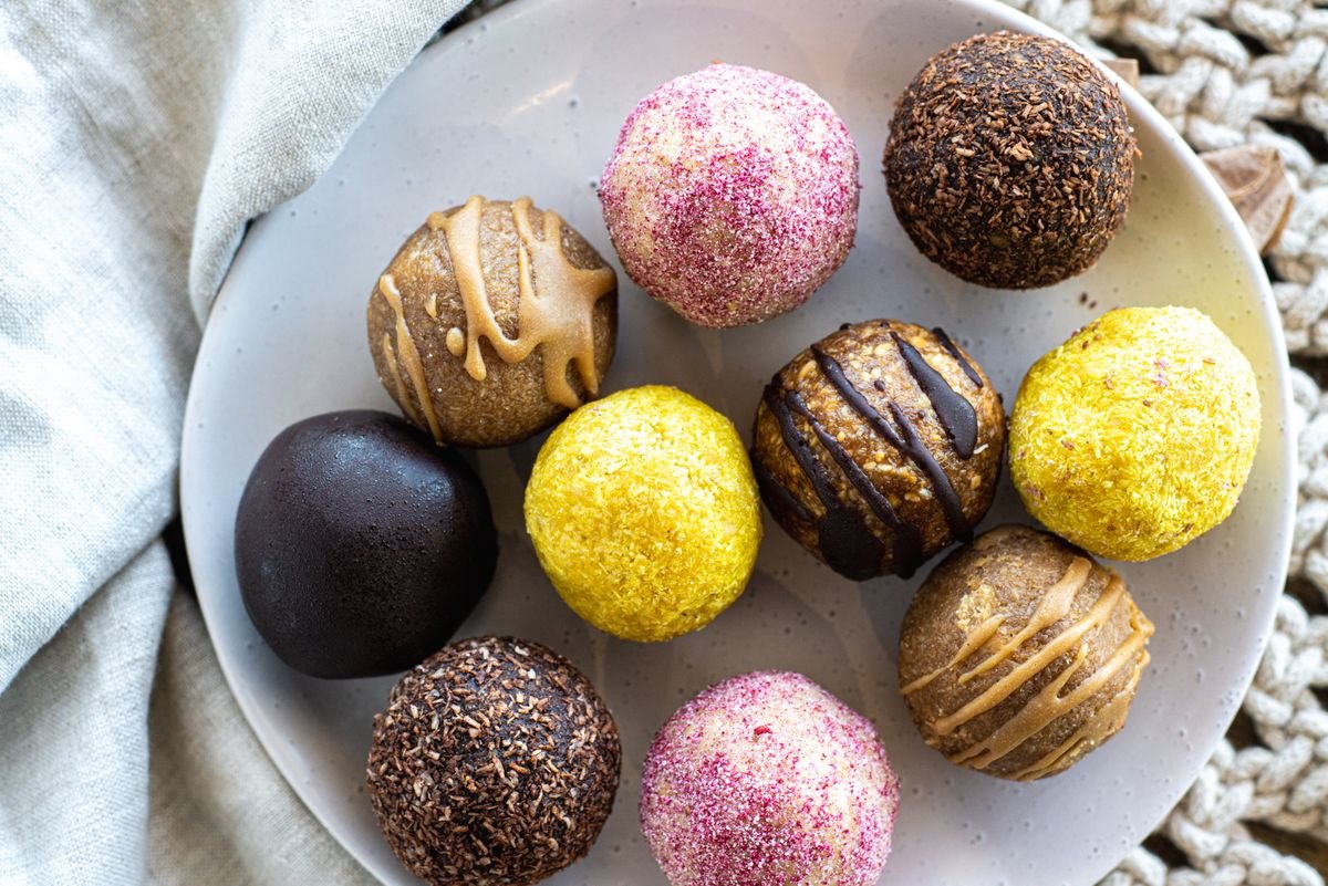 Chocolate coated Butterfinger balls setting on a baking sheet in the refrigerator