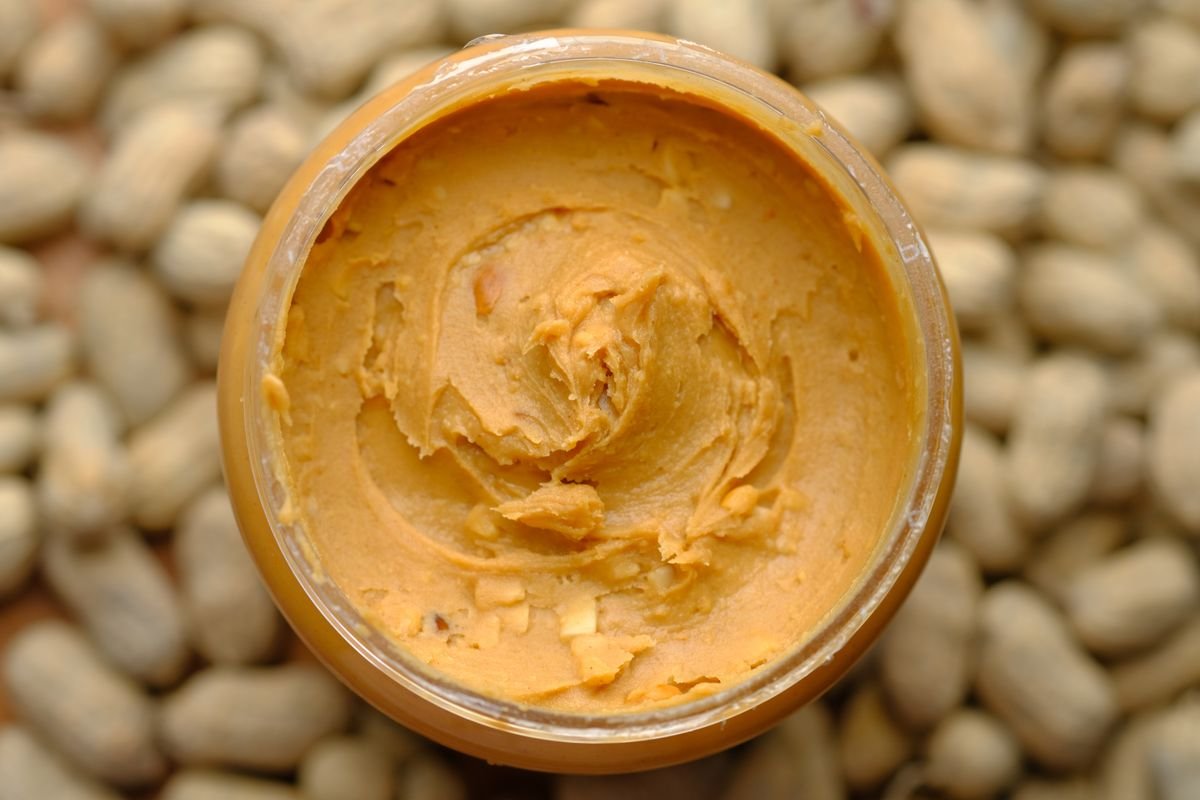 Butterfinger balls stored in an airtight container with parchment layers
