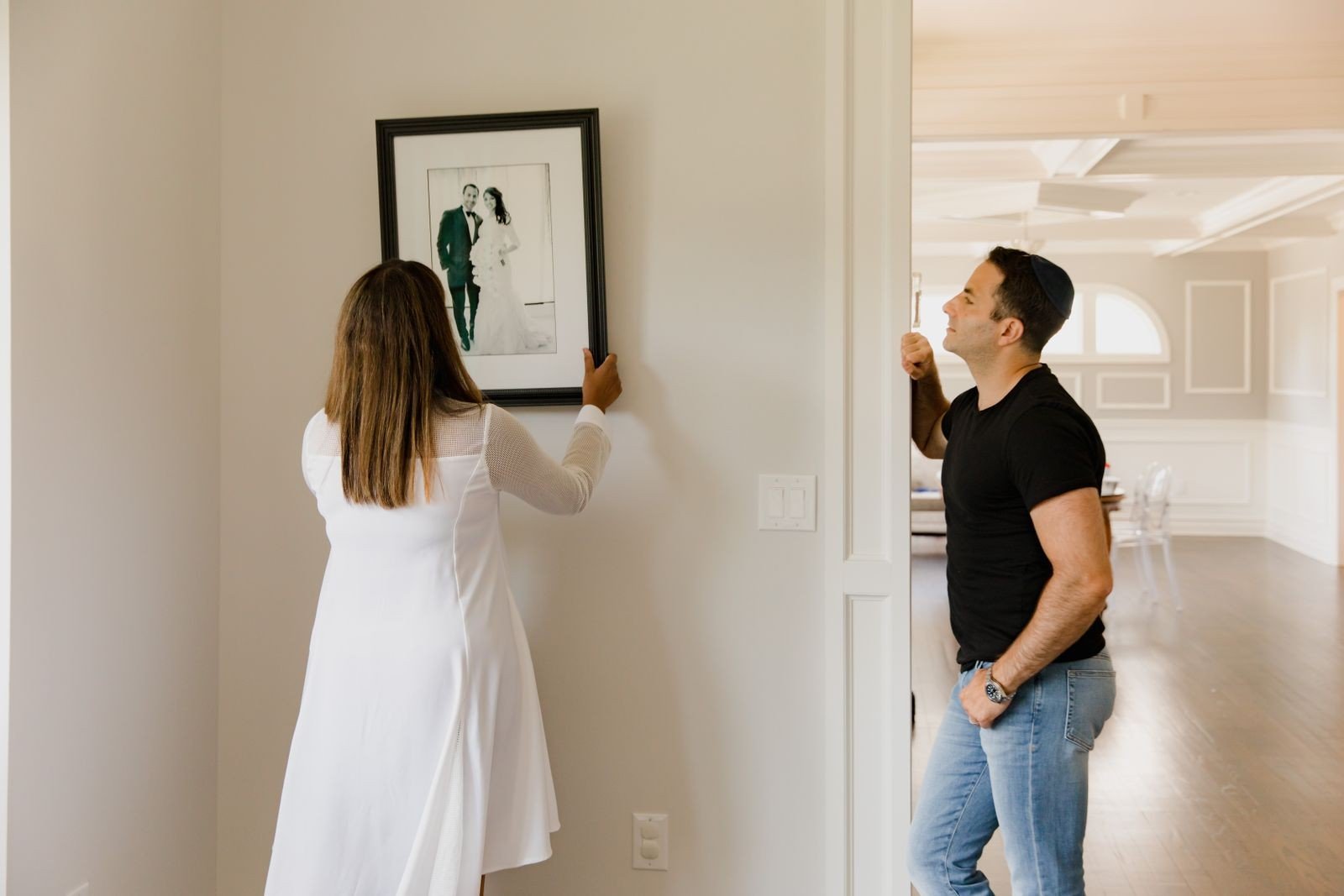 Black and white family portraits on a gallery wall
