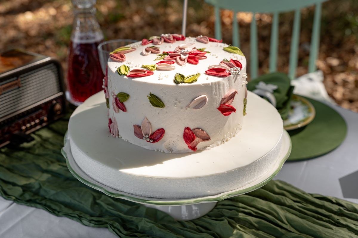 Flower pot cakes displayed on tiered stand at garden party
