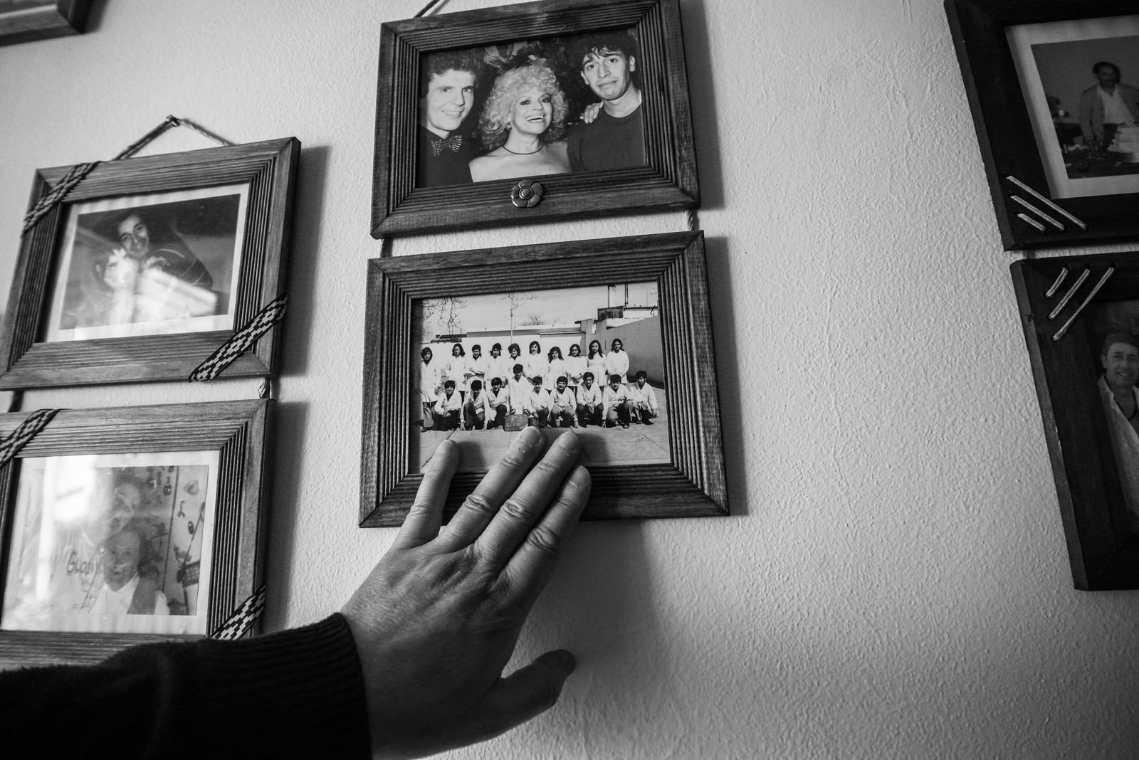 Family wall combining photos and children's artwork