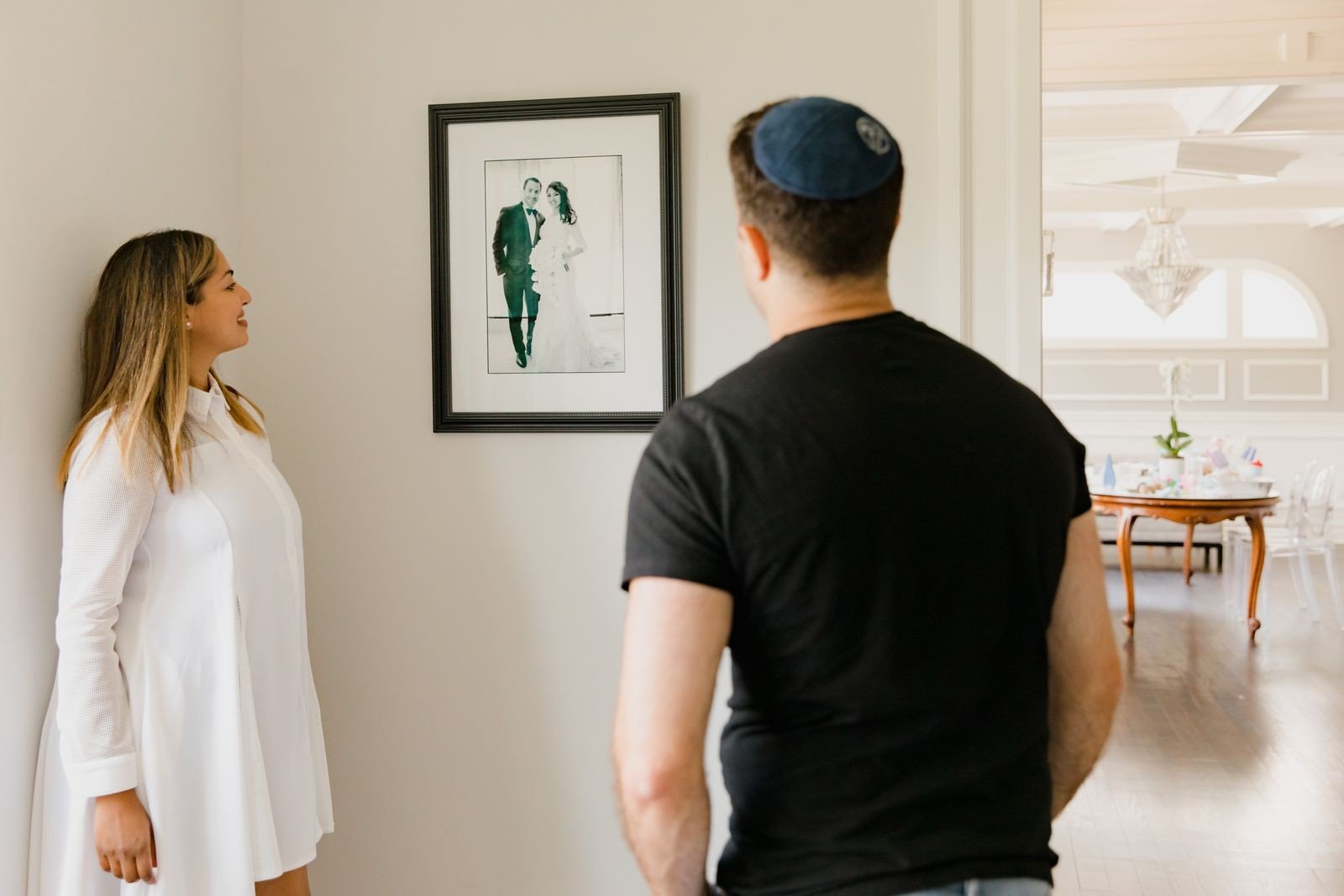 Picture lights illuminating a family photo wall