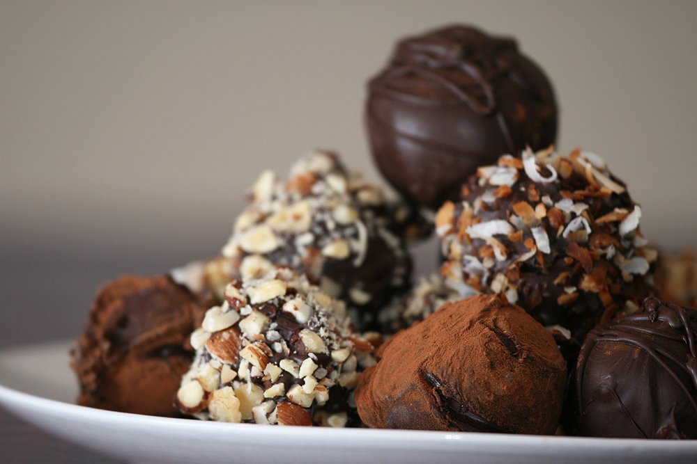 Large batch of Butterfinger balls prepared for a crowd on multiple baking sheets