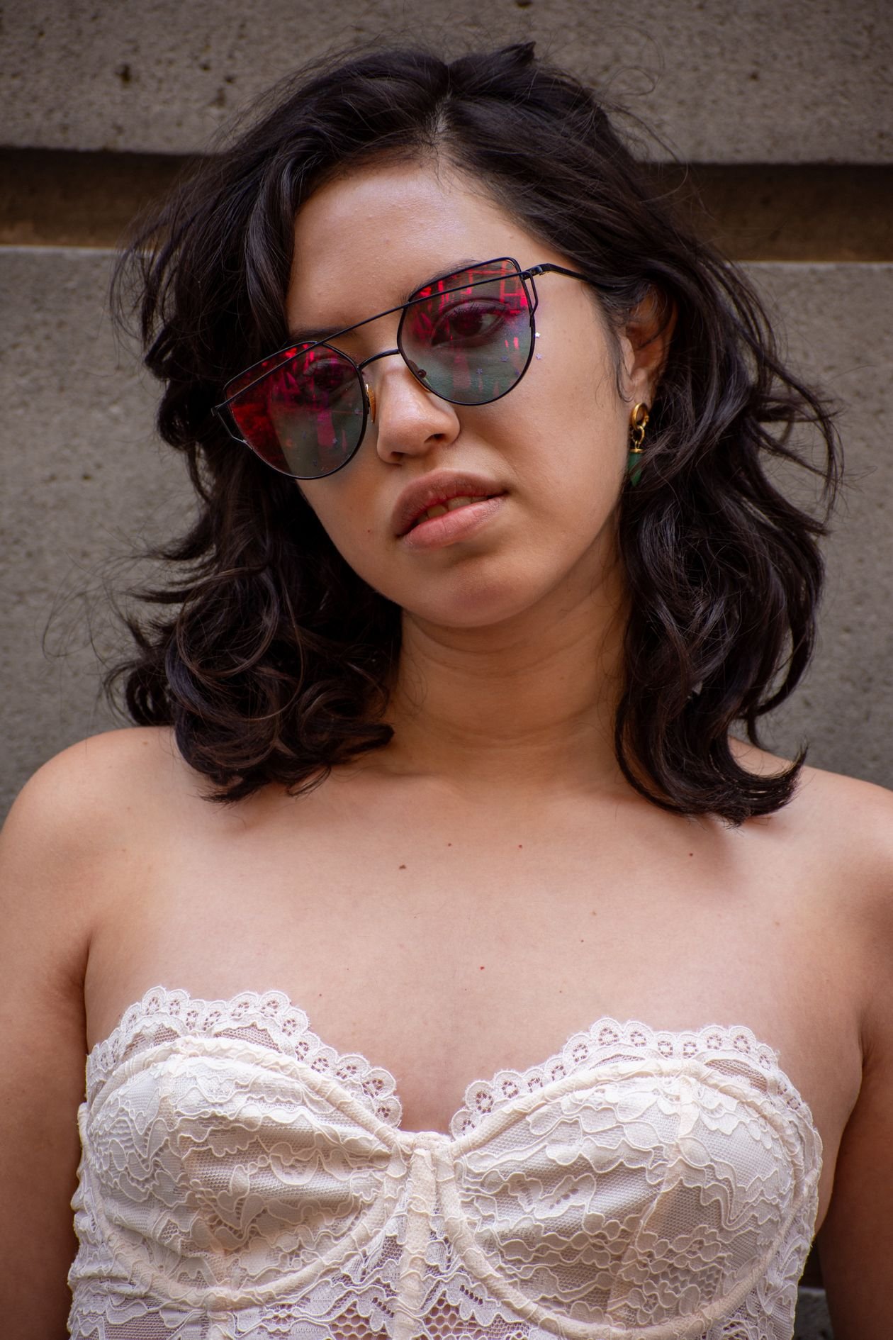 Woman in lace strapless top with sunglasses
