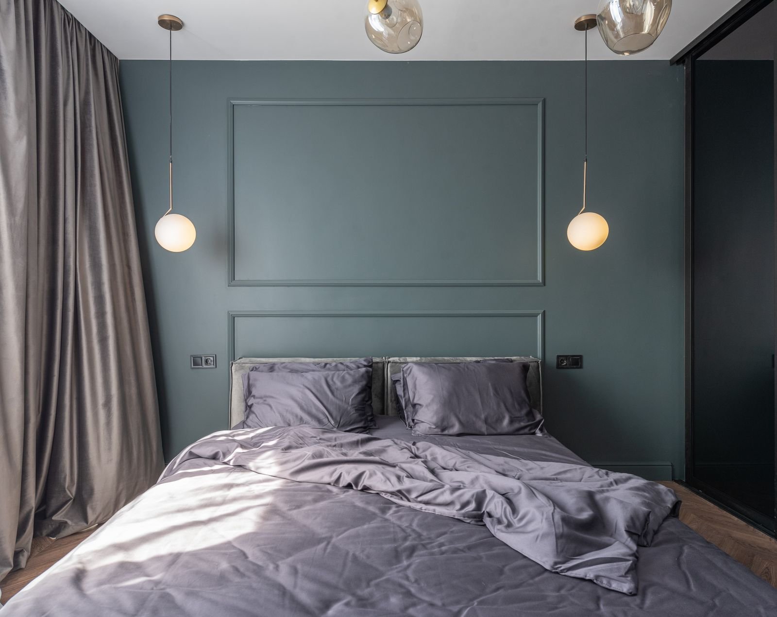 Ornate brass framed mirror reflecting elegant bedroom design with luxurious soft furnishings
