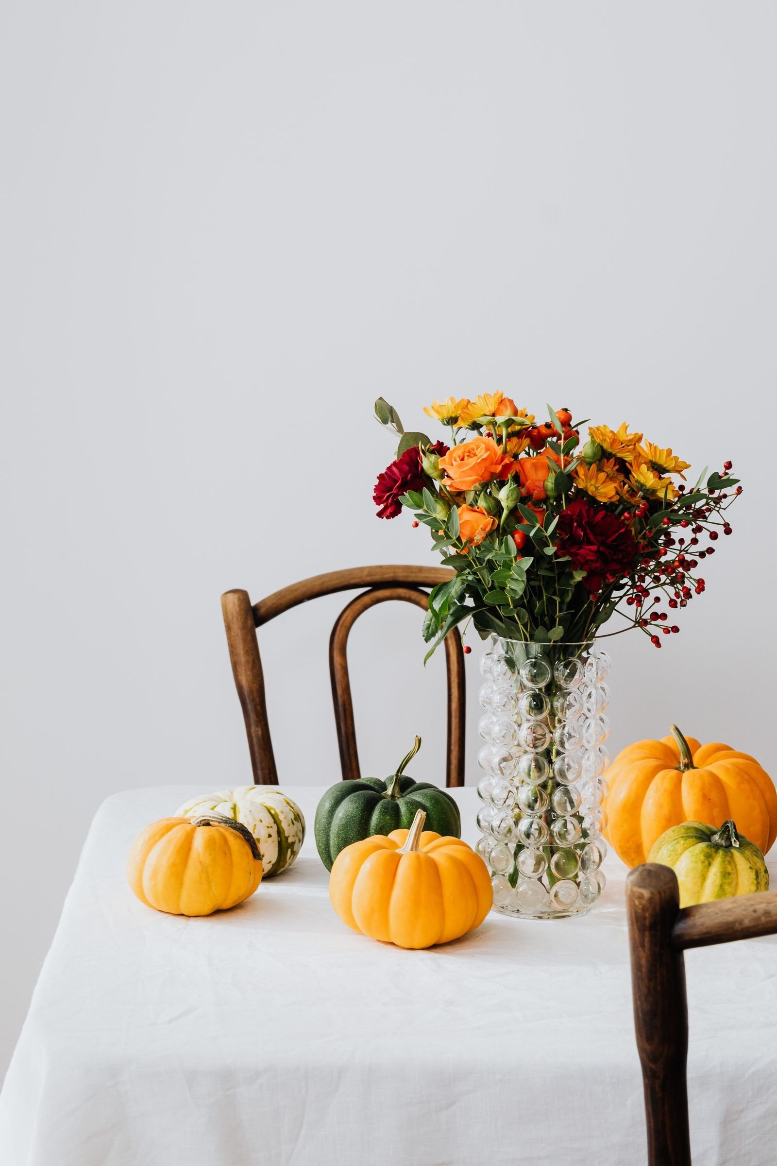 Low autumn floral arrangement with chrysanthemums and foliage