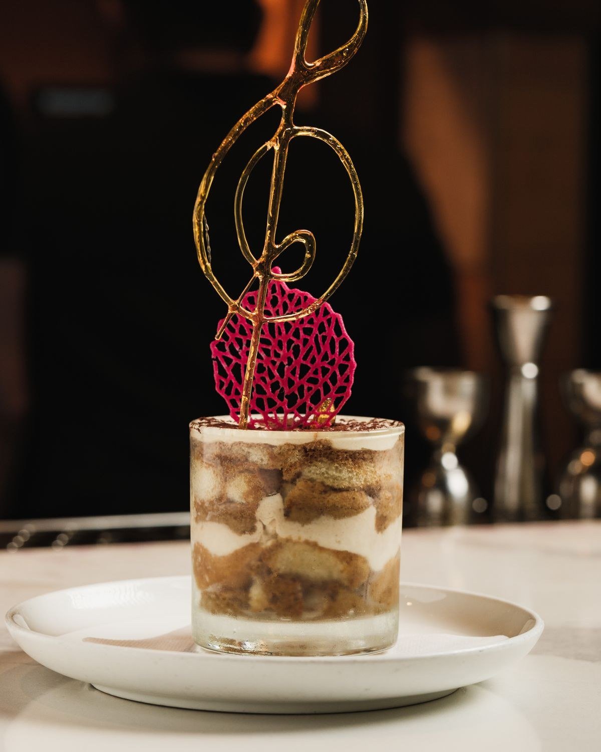 Tiramisu wedding cake decorated with figs berries and gold accents