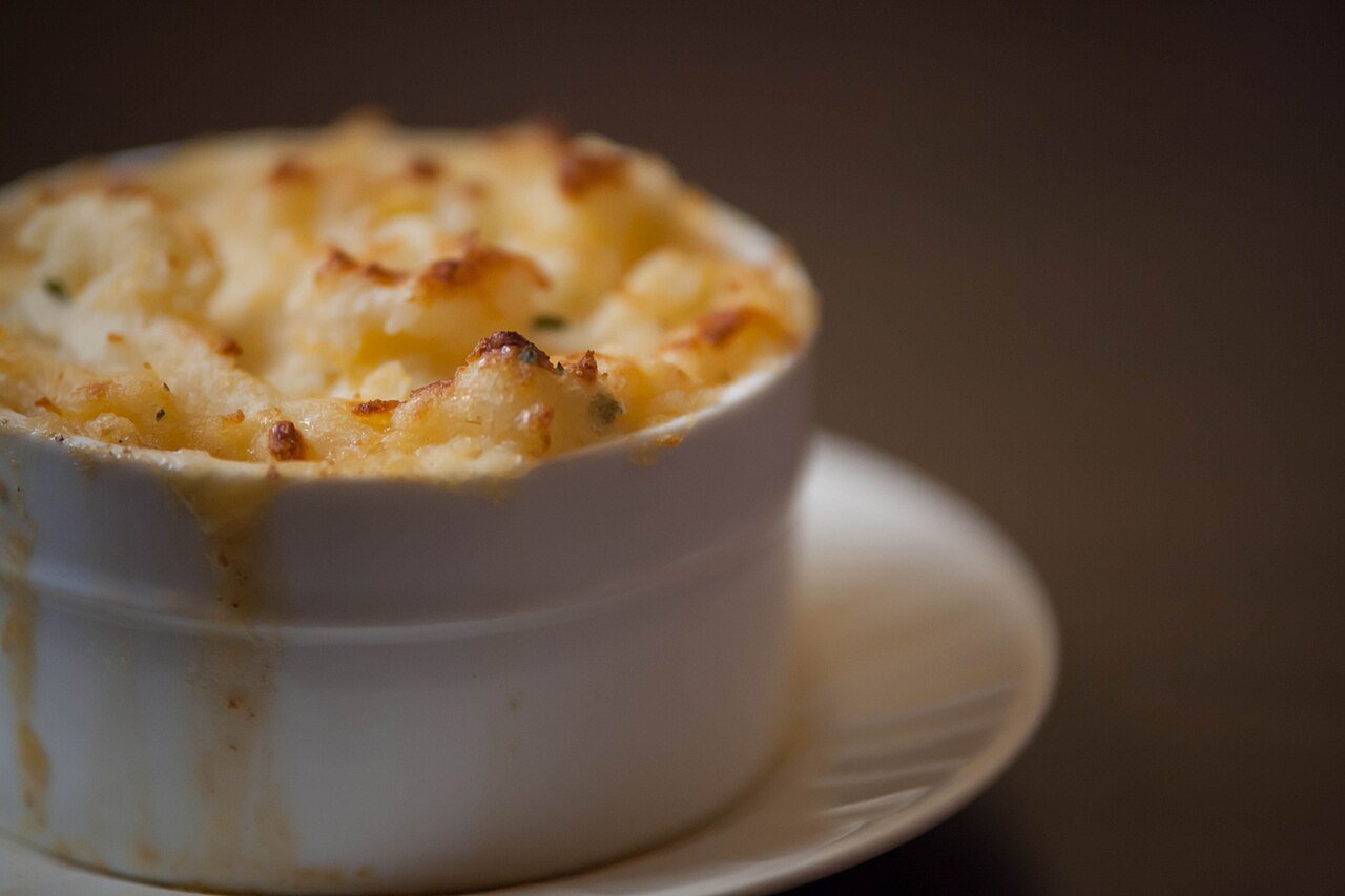 Mashing potatoes with butter and milk for creamy soup topping