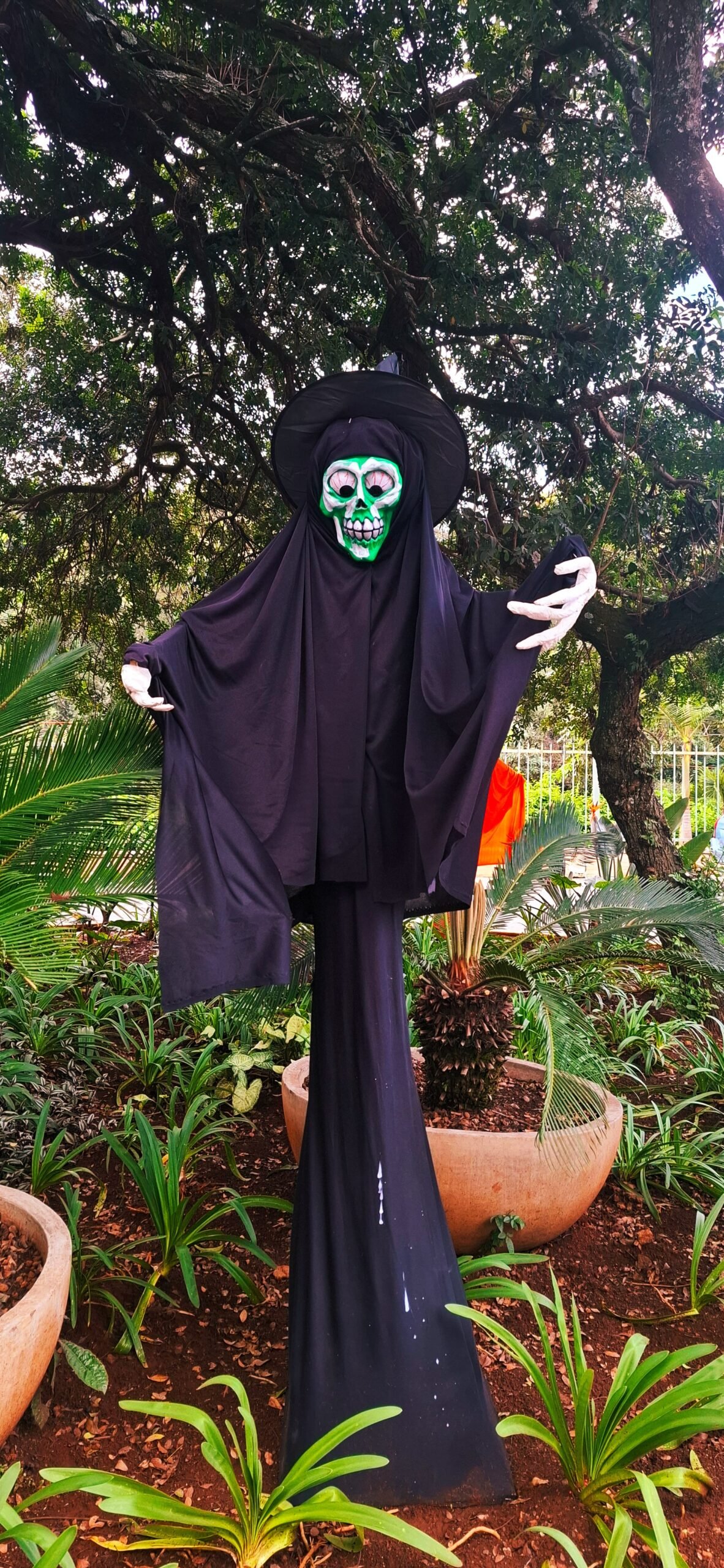 DIY tomato cage ghost ideas with ghosts decorating a front porch alongside pumpkins